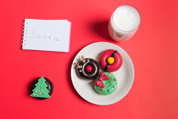 Letter, Donuts cookies and glass of milk for Santa on red background, concept Christmas and holiday. 
