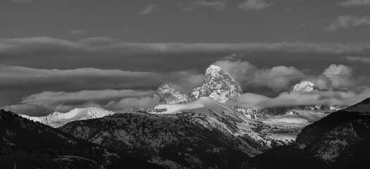Black and white panoramic of Layers of clouds blanket the Grand Teton and Teton Mountains, Wyoming