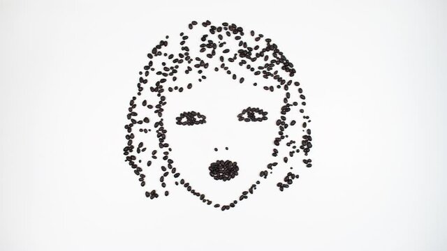 4k Chocolate girl sends a kiss. Face of young woman made from chocolate seeds. Concept of woman, femininity and love for chocolate. White background. Stop motion animation.