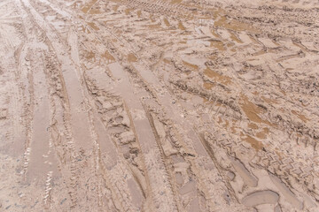 Track pattern trail from vehicle on dirty sandy road soil from wheel texture background