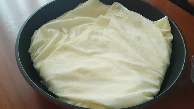 Video image of making pastry at home in a pan