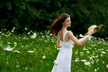 Woman in white dress hat nature field flowers