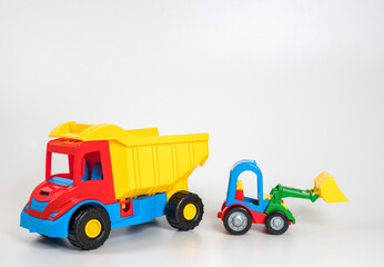 Multi-colored plastic children's toy cars on a white background.