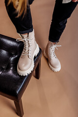 Young woman in beige stylish fashionable leather lace-up shoes. Fashionable collection of women's...