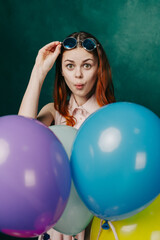 woman wearing fashionable glasses balloons holiday entertainment