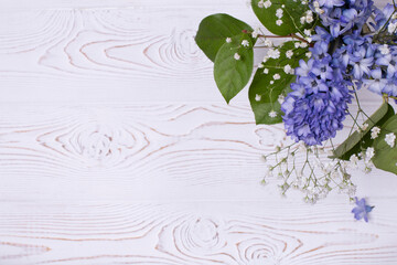 Spring composition with blue hyacinth flowers on a white whitewashed wooden table top. Flat lay. Copy space for text