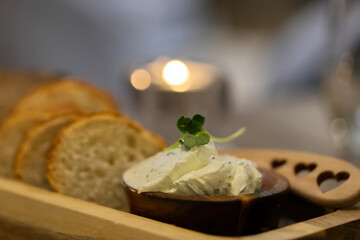 butter with bread on a wooden board in the restaurant close up