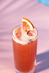 The exotic cocktail and fruit on color background