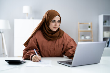 Muslim Woman With Laptop Calculating Finance