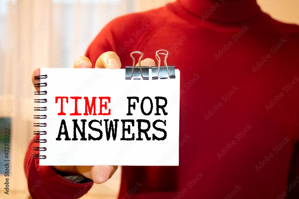 Poster on a pink background, pen and notebook with the text time for answers