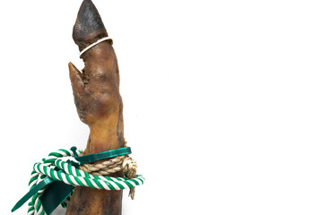 A hoof of a leg of a Spanish Serrano ham, with a green and white string, isolated on white...