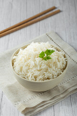 Bowl with cooked rice on the table.