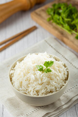 Bowl with cooked rice on the table.