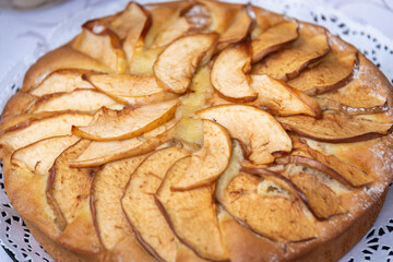 Round apple pie on the table.