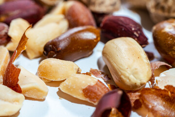 Peeled peanuts on a light surface.