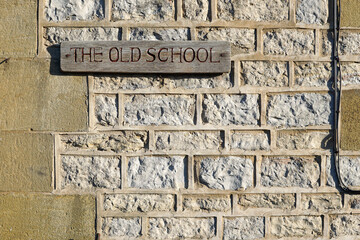 Harome, England - 26 November 2021 - A hand-carved wooden sign saying 