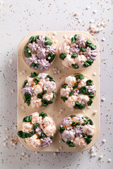 Delicious cupcakes made of sprinkles and white whipped cream.