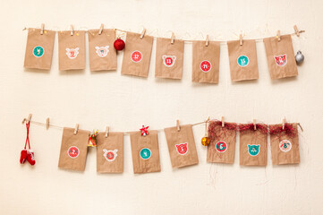 Advent calendar for Christmas hanging homemade from craft paper with pasted pictures on eco string...