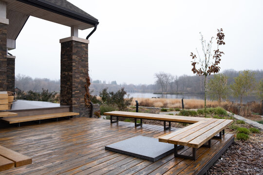 Wooden Deck Of Family Home. Terrace On Backyard With Wooden Bench And Beautiful View