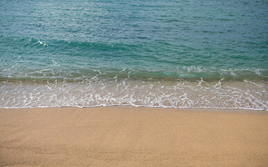 Beach background. Calm beautiful ocean wave on sandy beach. Sea view from tropical sea beach.