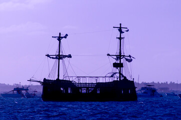 Old style ship silhouette at sunrise in the Caribbean, Punta Cana, Dominican Republic