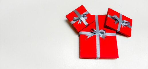 Closeup of Christmas Gift boxes wrapped with rippon decorated in a isolated White background with selective soft focus and copy space for inscription. Merry Christmas.