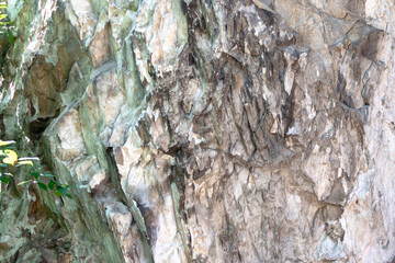 Abstract background. Stone formation of a sheer cliff close-up.