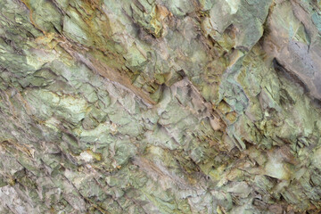 Abstract background. Stone formation of a sheer cliff close-up.