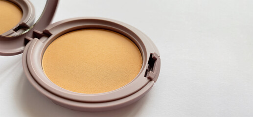 Compact powder for natural color make-up close-up isolated on a white background