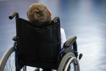 Ill disabled young boy in a wheelchair.