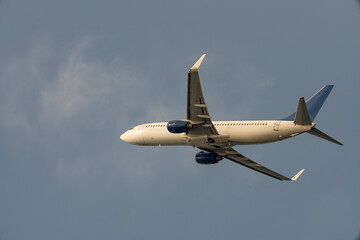 Passenger twin engine plane against the backdrop of a cloudy sky.