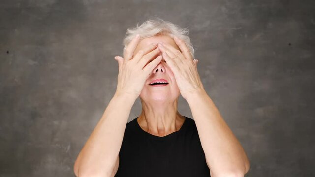 Happy smiling attractive middle aged woman touching face looking at camera. Advertising of skin care spa procedures concept. Closeup portrait