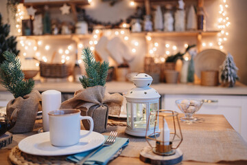 a cup of tea on the table in decorated kitchen for new year. electric garlands.