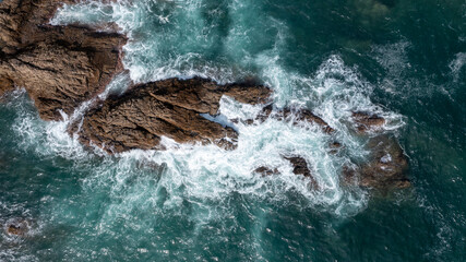Aerial view of sea crashing waves White foaming waves on seashore rocks,Sai Kung,Hong Kong