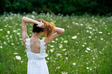 Obraz premium Woman in white dress in a field of flowers walk freedom