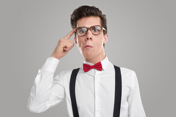 Funny smart geek in glasses in studio