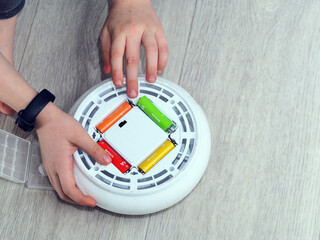 child hand paste batteries in toy