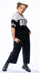 girl in the studio posing. model poses, in a tracksuit. street, youth style. isolated, white background. beauty concept. modern fashion