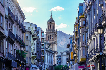 Main street of Jaen with its impressive cathedral in the background next to the mountains. Andalusia Spain. - obrazy, fototapety, plakaty