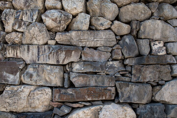 A wall of rough rough stones. Background of stones