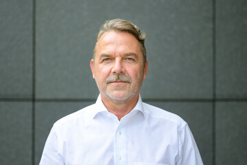 Portrait of smiling middle aged businessman in shirt