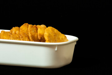 Farsi Puri In Square White Bowl, Copy Space On Right Side, Close-Up, Isolated on Black Background, Gujarati and Indian Snacks, White Flour (Maida), Namkeen, Crispy, Crunchy