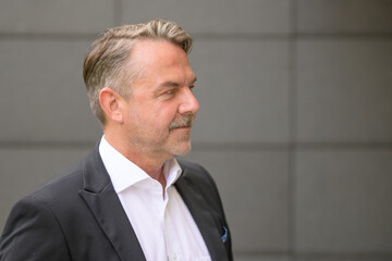 Portrait of a handsome middle-aged man wearing white shirt