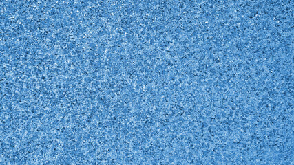 Blue winter background. Light tinted wallpaper. Ice crystals surface on window glass close-up. A pattern of chaotic spots. Abstract backdrop of frozen water