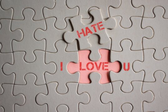 Concept of love hate relationship. I LOVE HATE U words written on pieces of jigsaw puzzle.