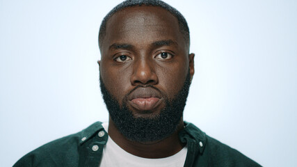 Portrait of positive african man making funny faces in grey background.