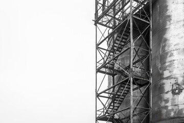 Fuel old chemical tank barrel oil in an industrial abandoned plant. Ladder to a dirty cistern