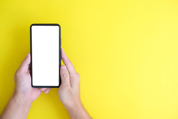 Hand using smartphone, banner, businessman or manager using phone on yellow background, internet marketing, office workplace