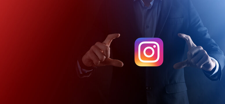 Onok,Ukraine - July 14,2021:Businessman holds, clicks, INSTAGRAM icon in his hands.Social network.global network and data customer connection.international network.