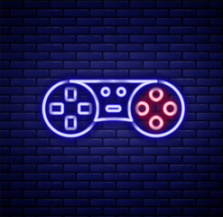 Glowing neon line Game controller or joystick for game console icon isolated on brick wall background. Colorful outline concept. Vector © Iryna